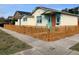 Charming residence showcasing a colorful facade and a quaint picket fence enhancing its curb appeal at 331 25Th S St, St Petersburg, FL 33712