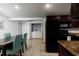Bright kitchen and dining area with tile floors, black appliances, and a convenient laundry closet at 331 25Th S St, St Petersburg, FL 33712