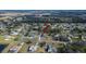 Beautiful aerial view of a single-Gathering home in a suburban neighborhood with tree coverage and nearby lake at 9413 Swift Creek Cir, Dover, FL 33527