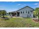 Expansive backyard featuring a covered patio and well-maintained lawn perfect for outdoor entertaining at 9413 Swift Creek Cir, Dover, FL 33527