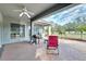 Relaxing backyard patio featuring comfortable seating, barbecue grill, and open views to the yard at 9413 Swift Creek Cir, Dover, FL 33527