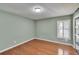 Light-filled room with hardwood flooring and plantation shutters for privacy at 9413 Swift Creek Cir, Dover, FL 33527