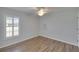 Bright bedroom features wood-look floors, white trim, and a ceiling fan at 9413 Swift Creek Cir, Dover, FL 33527