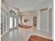 Inviting foyer with tiled floors, decorative lighting, and double doors leading to the living area at 9413 Swift Creek Cir, Dover, FL 33527