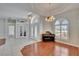 Inviting foyer featuring tiled floors, decorative lighting, and views into the main living area at 9413 Swift Creek Cir, Dover, FL 33527