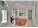 Welcoming foyer with elegant lighting, a piano, and views into other areas of the home at 9413 Swift Creek Cir, Dover, FL 33527