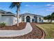 Charming single-story home featuring lush landscaping and a curved walkway at 9413 Swift Creek Cir, Dover, FL 33527
