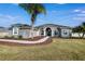 Elegant home with a manicured lawn, a curving walkway, and stunning curb appeal at 9413 Swift Creek Cir, Dover, FL 33527