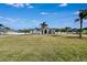 Expansive front yard showcasing a beautiful home with a circular driveway and mature landscaping at 9413 Swift Creek Cir, Dover, FL 33527
