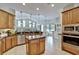 Gourmet kitchen with center island, stainless appliances, and views to the dining area at 9413 Swift Creek Cir, Dover, FL 33527