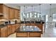Open kitchen with center island, breakfast bar, and views to living room at 9413 Swift Creek Cir, Dover, FL 33527
