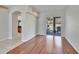 Bright living room featuring hardwood floors and sliding glass doors to the outdoor patio at 9413 Swift Creek Cir, Dover, FL 33527