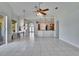 Spacious living room with open floor plan, tile floors, and view to the kitchen at 9413 Swift Creek Cir, Dover, FL 33527