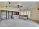 Living room features a ceiling fan, built-in bookshelves, and a comfortable sectional sofa at 9413 Swift Creek Cir, Dover, FL 33527
