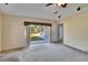 Spacious living room featuring sliding glass doors to a brick-paved patio and green lawn at 9413 Swift Creek Cir, Dover, FL 33527