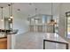 Bright living room featuring a high ceiling, tiled floors, and sliding doors to the outdoor patio at 9413 Swift Creek Cir, Dover, FL 33527