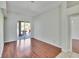 Spacious living room featuring hardwood floors and sliding glass doors to the outdoor patio at 9413 Swift Creek Cir, Dover, FL 33527