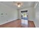 Bright living room features hardwood floors, fan, and sliding glass doors to a backyard patio at 9413 Swift Creek Cir, Dover, FL 33527