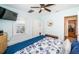 Comfortable bedroom with a ceiling fan, window, and storage closet at 1000 Oak St, Dunedin, FL 34698