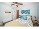 Bedroom with a beachy theme, light blue walls and comfortable furniture and nautical decor at 1000 Oak St, Dunedin, FL 34698