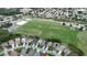 Overhead view of the community, showing soccer fields, tennis courts, and neighborhood homes with solar panels at 1919 Blue River Rd, Holiday, FL 34691