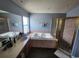 Bathroom showcasing a soaking tub, glass shower, and double vanity at 1919 Blue River Rd, Holiday, FL 34691