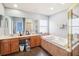 Bathroom featuring a large soaking tub and a glass-enclosed shower at 1919 Blue River Rd, Holiday, FL 34691