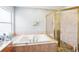 Relaxing bathroom with a soaking tub and a glass-enclosed shower at 1919 Blue River Rd, Holiday, FL 34691