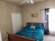 Cozy bedroom featuring a ceiling fan, closet, and natural light from the window at 1919 Blue River Rd, Holiday, FL 34691