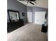 Neutral toned bedroom with high ceilings, large closet, and a modern black dresser at 1919 Blue River Rd, Holiday, FL 34691