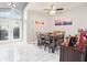 The dining room has a tall window, modern ceiling fan, and colorful artwork on the wall at 1919 Blue River Rd, Holiday, FL 34691