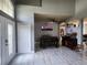 The dining room features modern tiling, a ceiling fan, and an arched entry to the Gathering room at 1919 Blue River Rd, Holiday, FL 34691