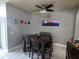 The dining room features modern tiling, a ceiling fan, and colorful artwork on the wall at 1919 Blue River Rd, Holiday, FL 34691