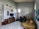 This living room features tall ceilings, modern tiling, a workspace, and an entertainment area at 1919 Blue River Rd, Holiday, FL 34691