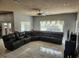 Inviting living room with large sectional sofa, tile floors, and view of the pool at 1919 Blue River Rd, Holiday, FL 34691