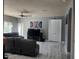 Open-concept living room featuring tile floors, modern decor, and comfortable seating at 1919 Blue River Rd, Holiday, FL 34691