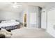 Cozy bedroom with carpet, white ceiling fan, and ensuite bathroom at 1919 Blue River Rd, Holiday, FL 34691