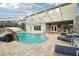 Enjoy this private, screened pool with a waterfall feature, patio, and bar area for entertaining at 1919 Blue River Rd, Holiday, FL 34691