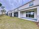 A backyard boasts a covered patio, green grass, and is great for outdoor living and entertaining at 32535 Turtle Grace Loop, Wesley Chapel, FL 33545
