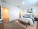 Inviting primary bedroom featuring a neutral color palette, plush bedding, and ensuite bathroom access at 32535 Turtle Grace Loop, Wesley Chapel, FL 33545