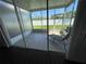 View of the screened lanai from the interior, furnished with a lounge chair at 4842 Pond Ridge Dr, Riverview, FL 33578