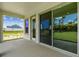 Covered porch view of manicured lawn and blue house at 5283 Everlong Dr, Apollo Beach, FL 33572