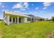 Grassy backyard featuring a well-maintained lawn and the rear of the house at 5283 Everlong Dr, Apollo Beach, FL 33572