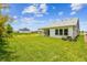 Large backyard featuring green lawn and a view of the home's rear exterior with a covered patio at 5283 Everlong Dr, Apollo Beach, FL 33572