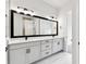 Bathroom featuring a double vanity, sleek black fixtures, and modern lighting at 5283 Everlong Dr, Apollo Beach, FL 33572