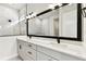Bathroom with a double vanity, white marble floors, and sleek black fixtures at 5283 Everlong Dr, Apollo Beach, FL 33572