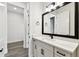 Bright bathroom with modern vanity, matte black fixtures and a decorative mirror at 5283 Everlong Dr, Apollo Beach, FL 33572