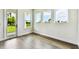 Flex space with wood-look floors featuring a door leading outside and multiple windows for natural light at 5283 Everlong Dr, Apollo Beach, FL 33572