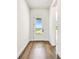 Bright foyer featuring wood floors, white walls, and a clear glass front door at 5283 Everlong Dr, Apollo Beach, FL 33572