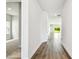 Long hallway with wood floors leads to the open living spaces and bedrooms at 5283 Everlong Dr, Apollo Beach, FL 33572